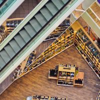 Aerial view of a stylish shopping mall showcasing escalators and well-organized retail displays.
