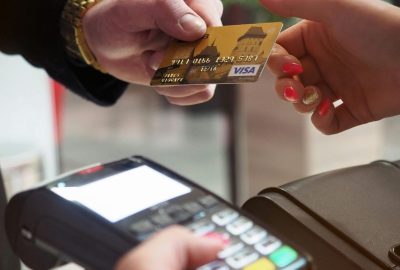 Close-up of a credit card payment being processed at a POS terminal.